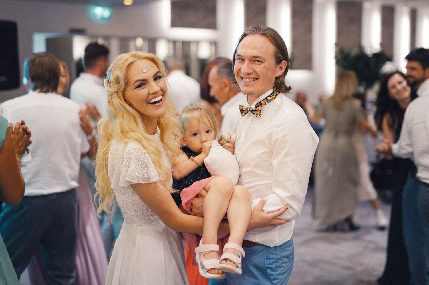 Family enjoys a festive celebration together in a decorated indoor venue.