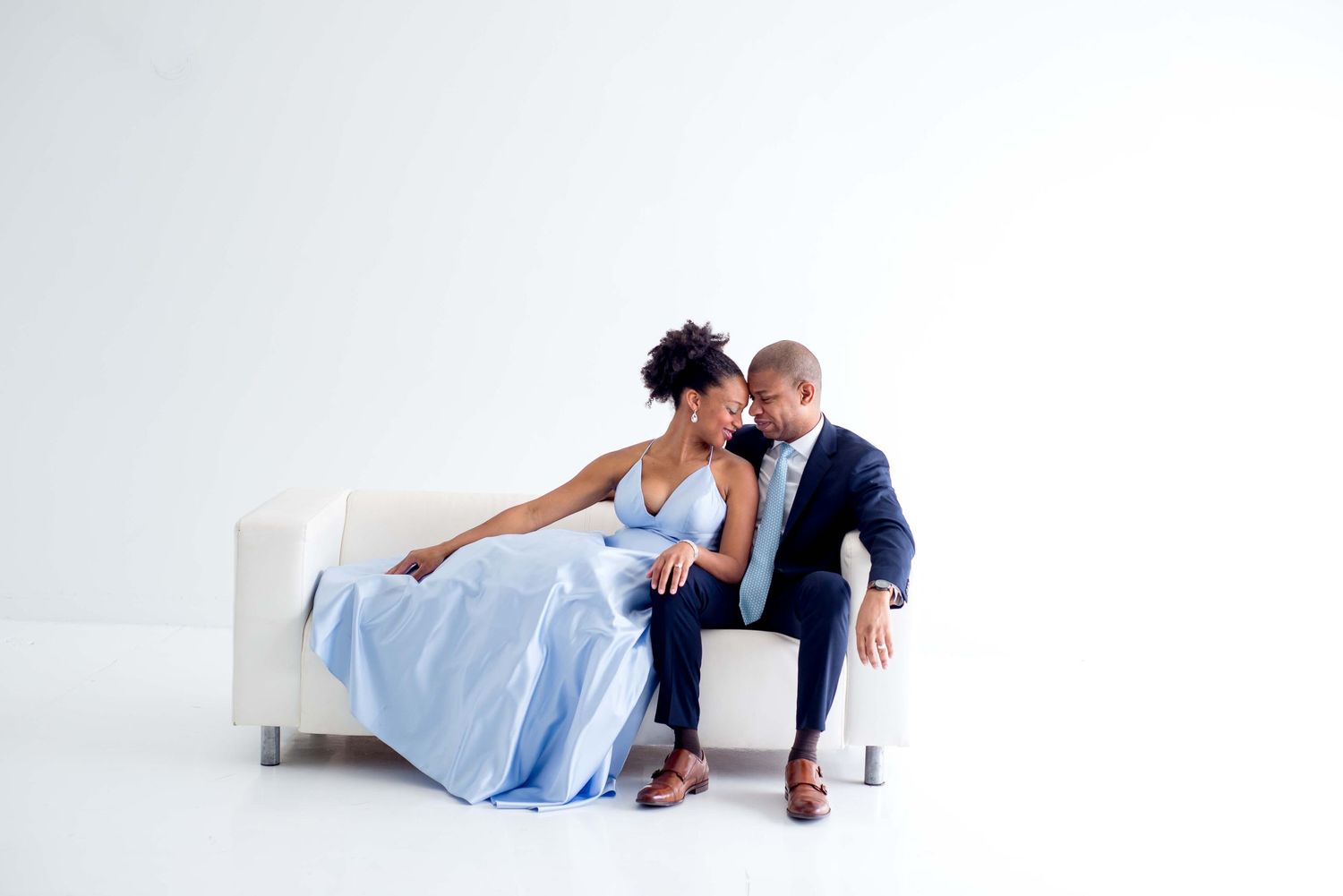husband and wife portraits in white studio