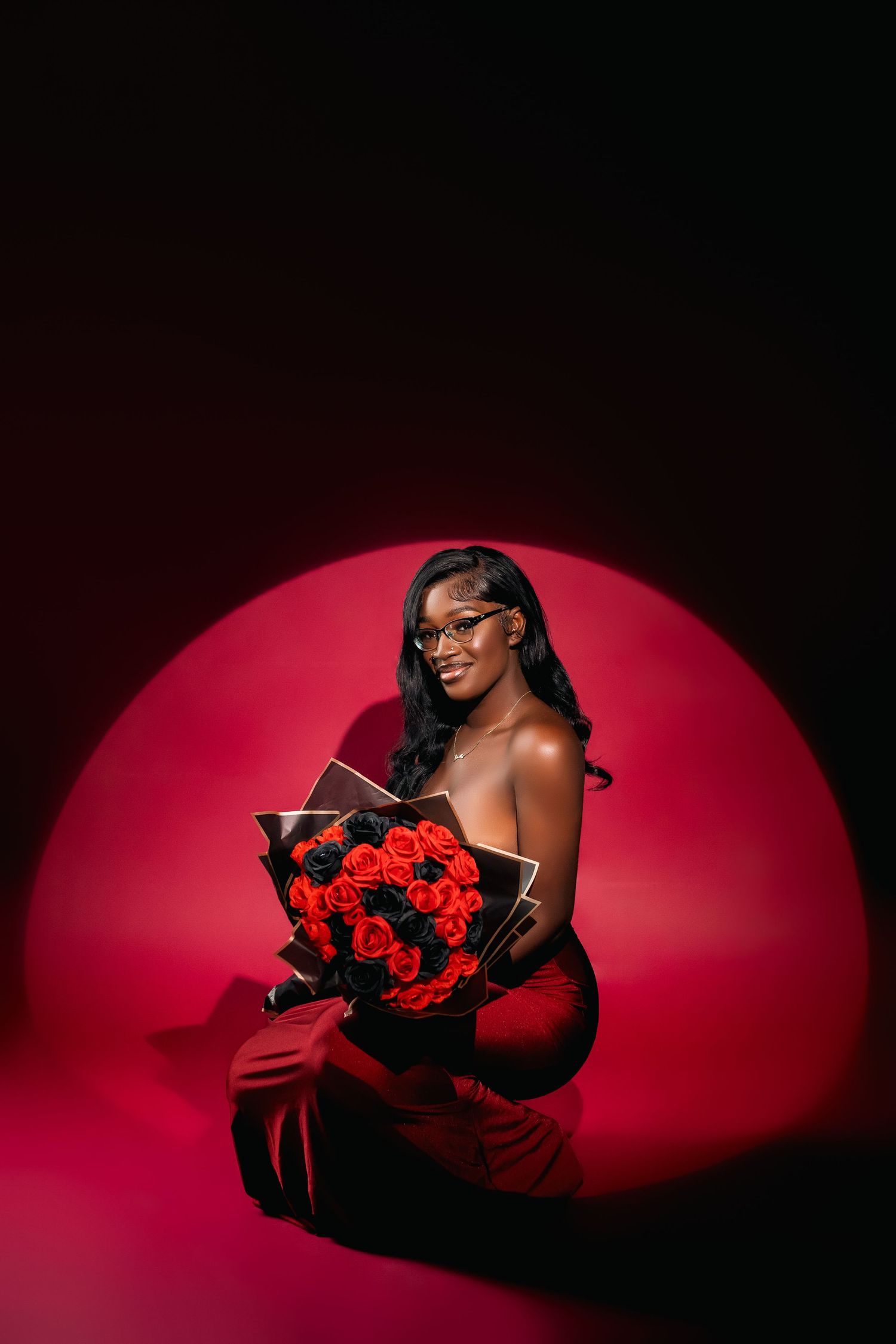 Romantic portrait with red roses against dramatic red circular backdrop.