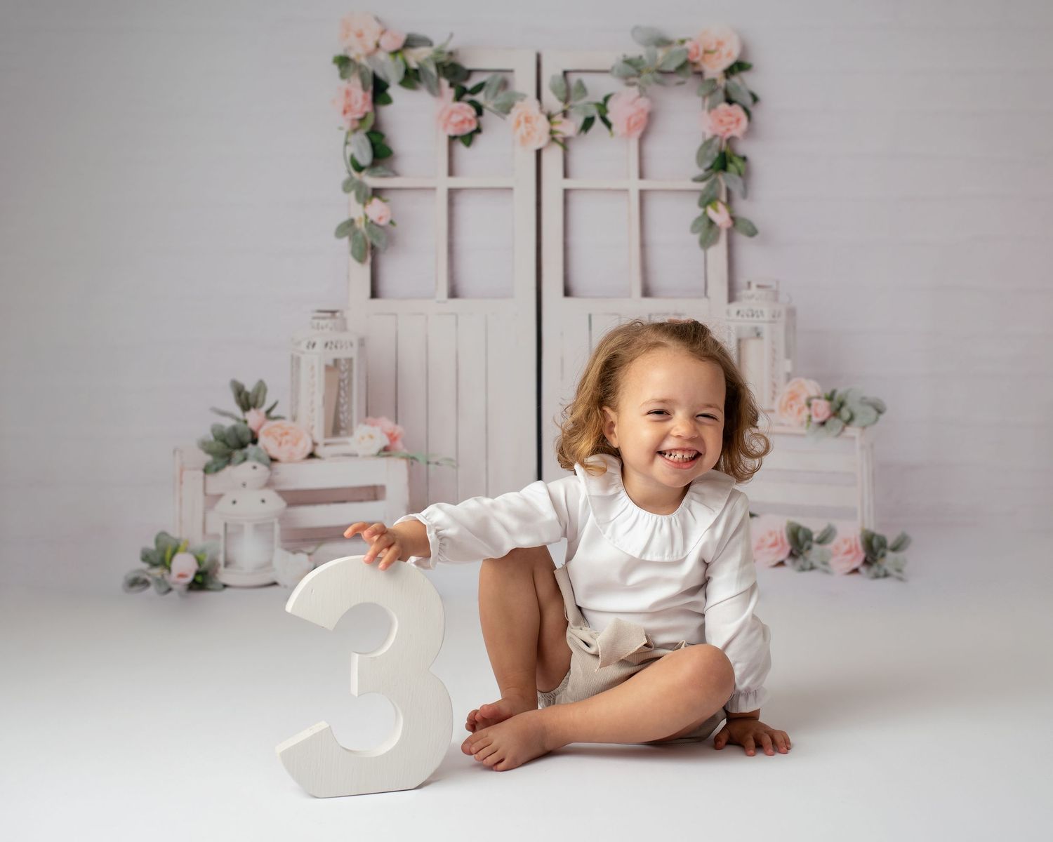 girl smiling holding number 3