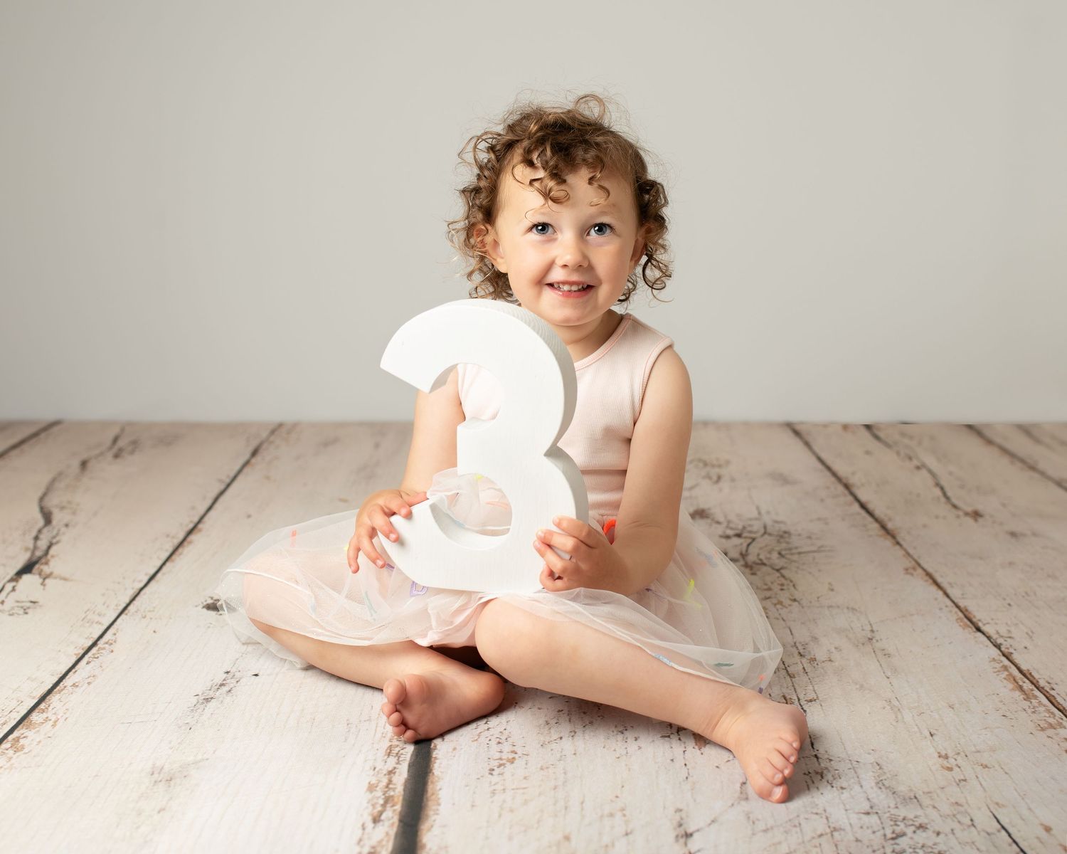girl holding number 3