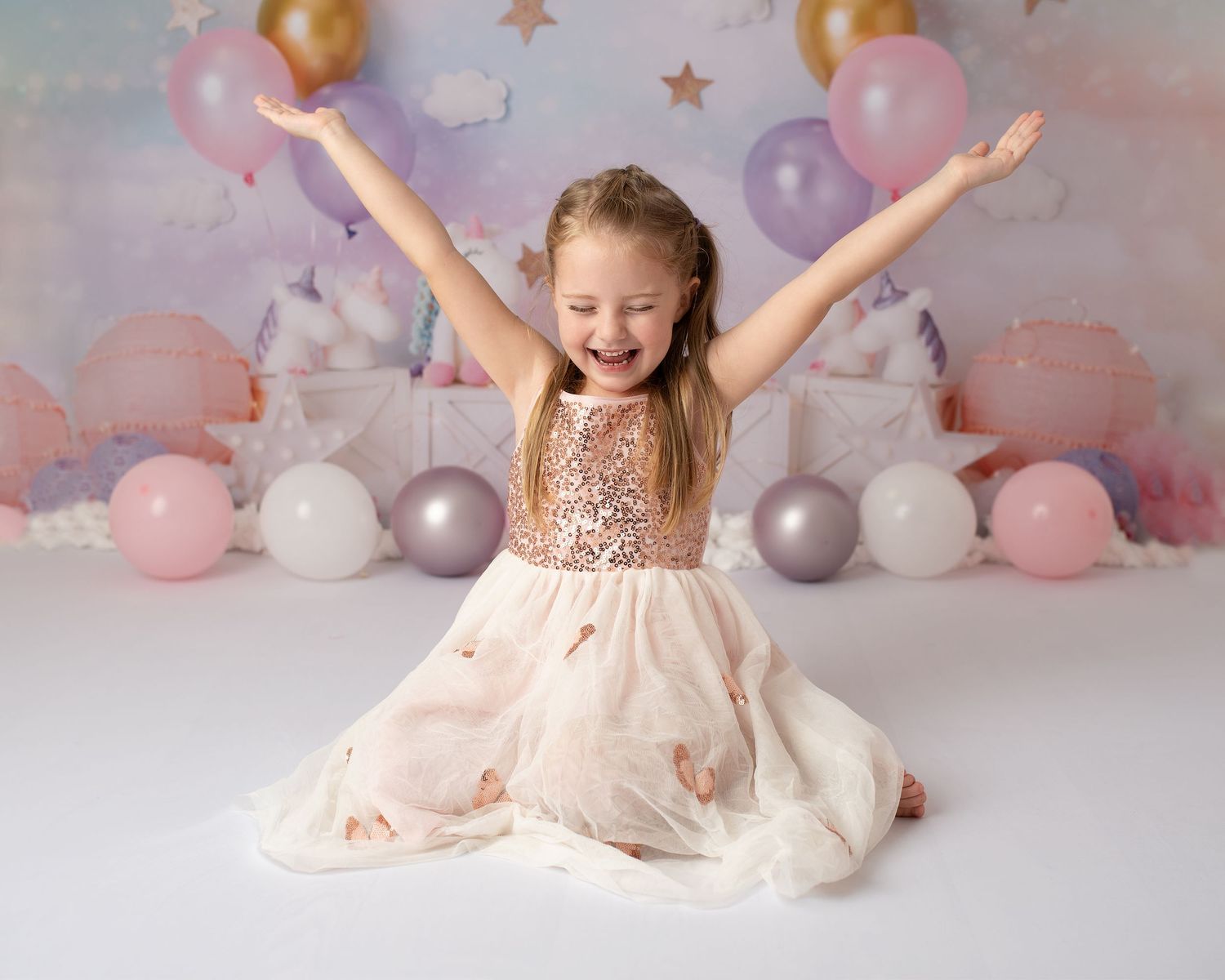 girl celebrating being 6 with arms raised