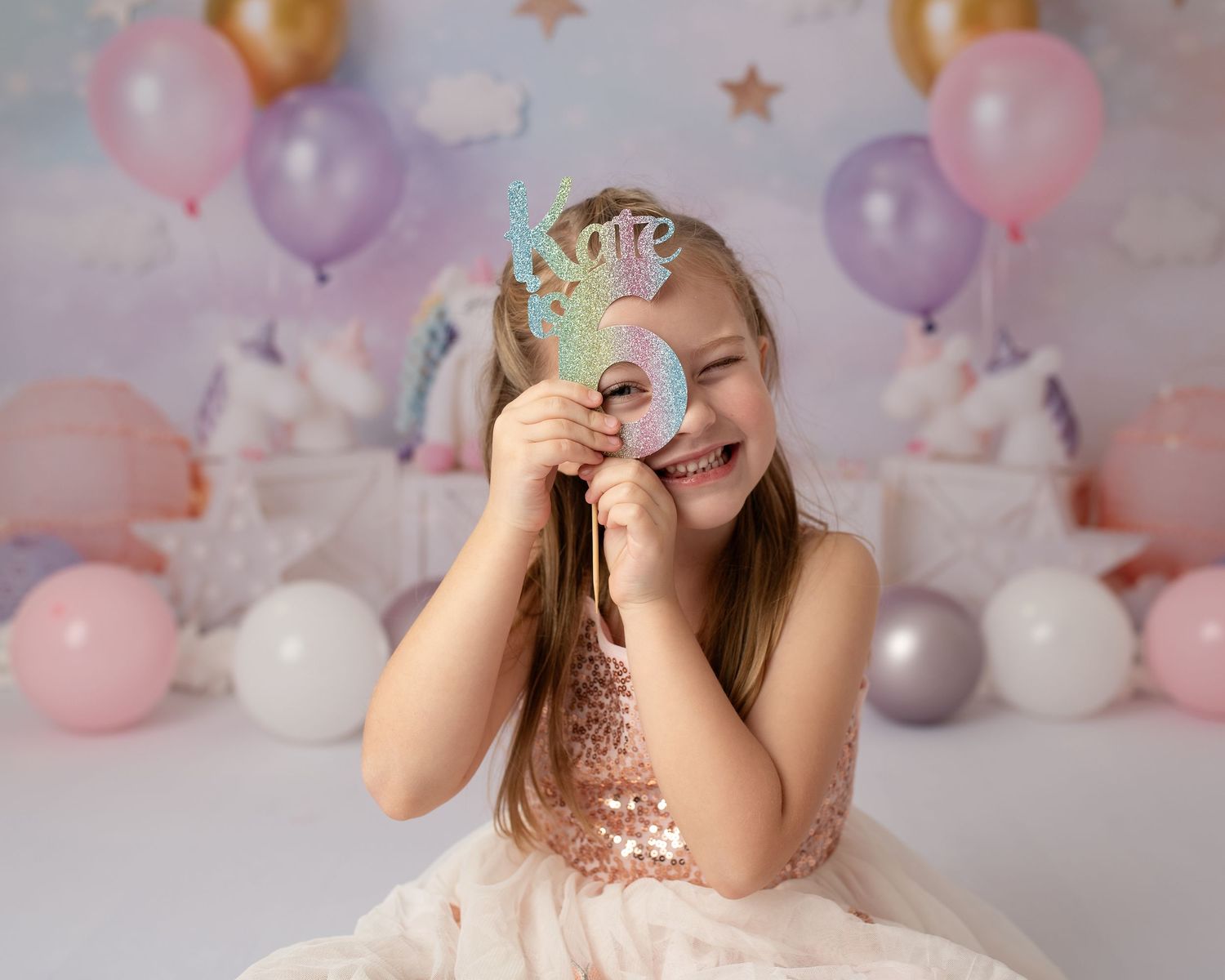girl looking through a party decoration