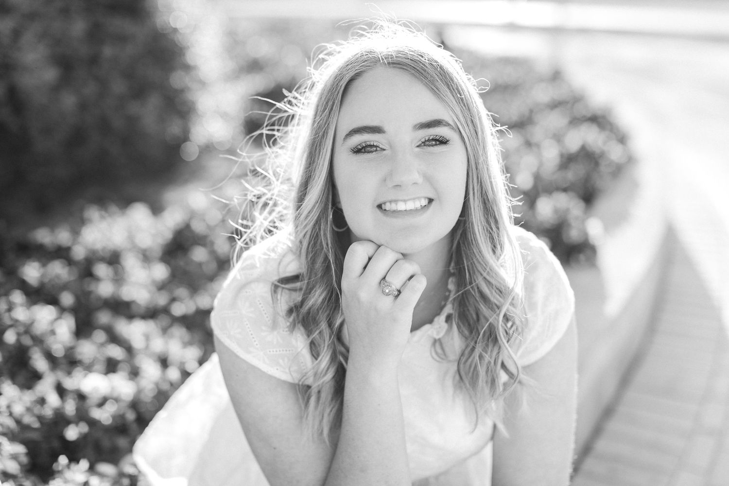 Black and white outdoor portrait with natural candid expression.