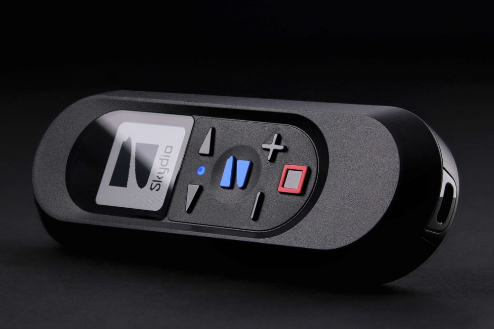 The Skydio Beacon staged on a dark background with low-key lighting.