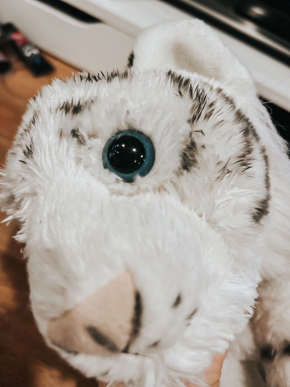 Close up of repaired eye on stuffed white tiger.