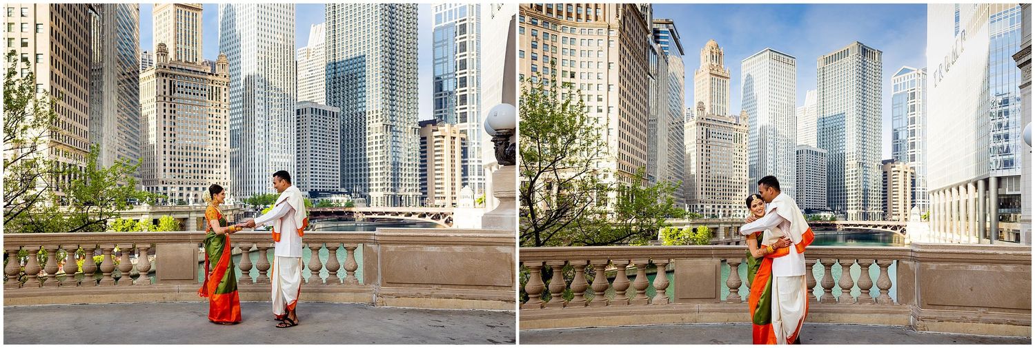 Couple in traditional Indian wedding attire posing against Chicago cityscape backdrop.