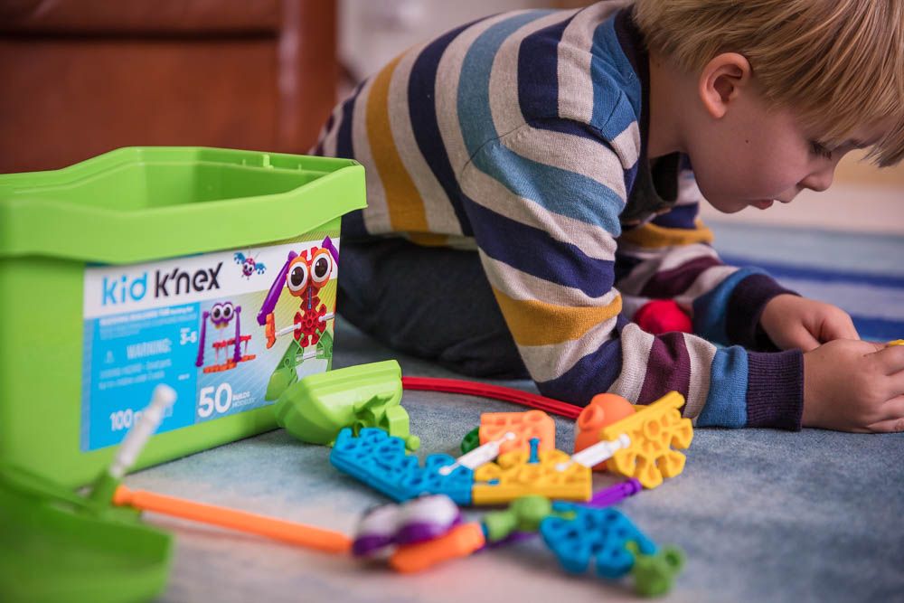 Child playing with K'Nex, product photography
