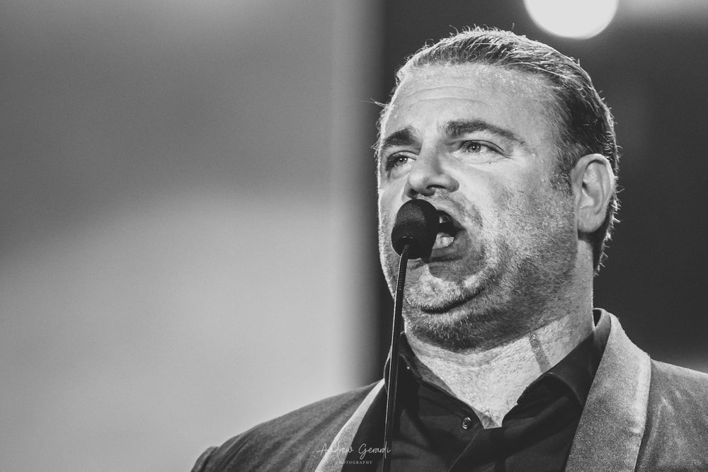 Black and white performance shots showing emotional expressions during a concert.