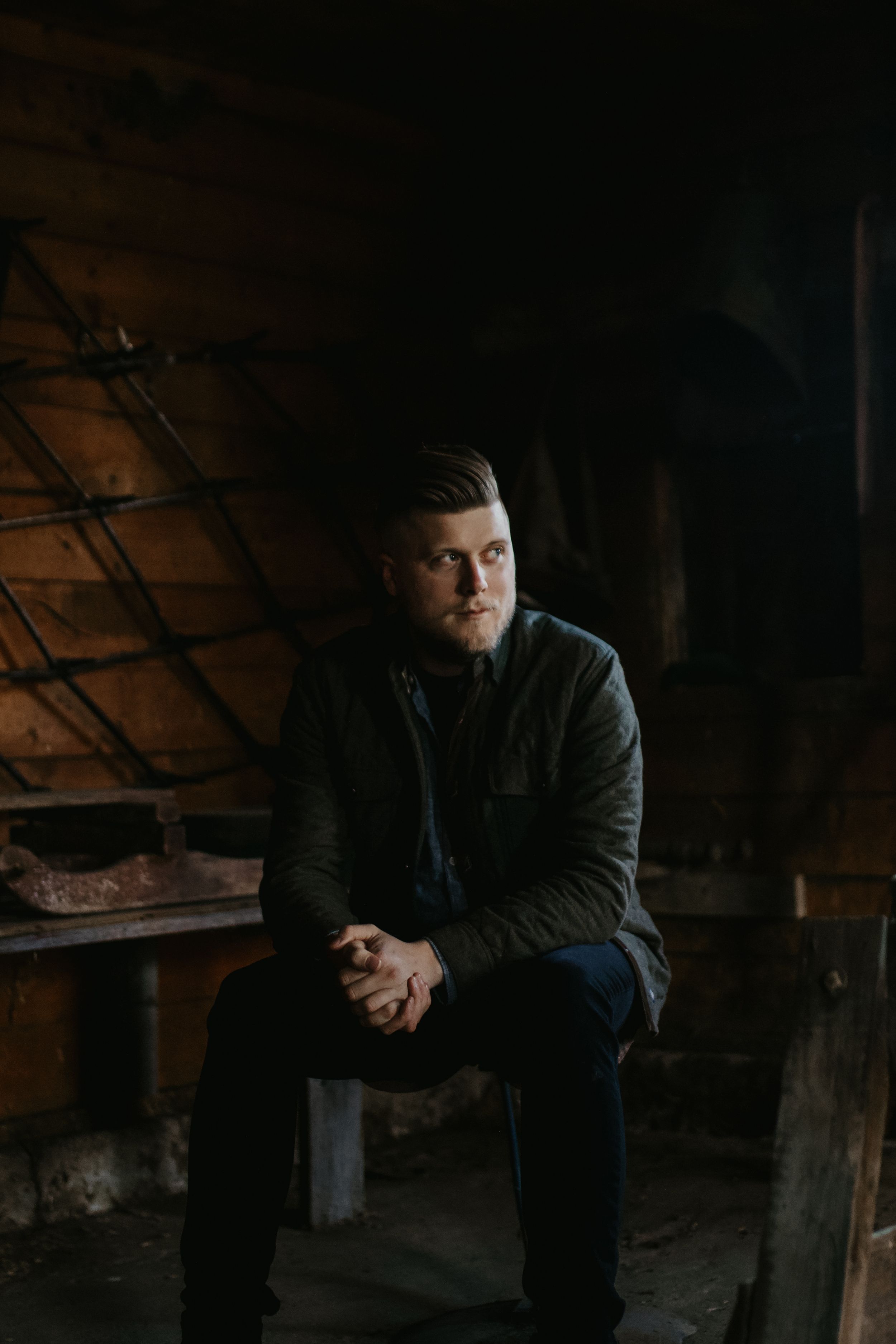 moody male portrait in old barn
