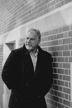 classic male portrait in front of brick wall