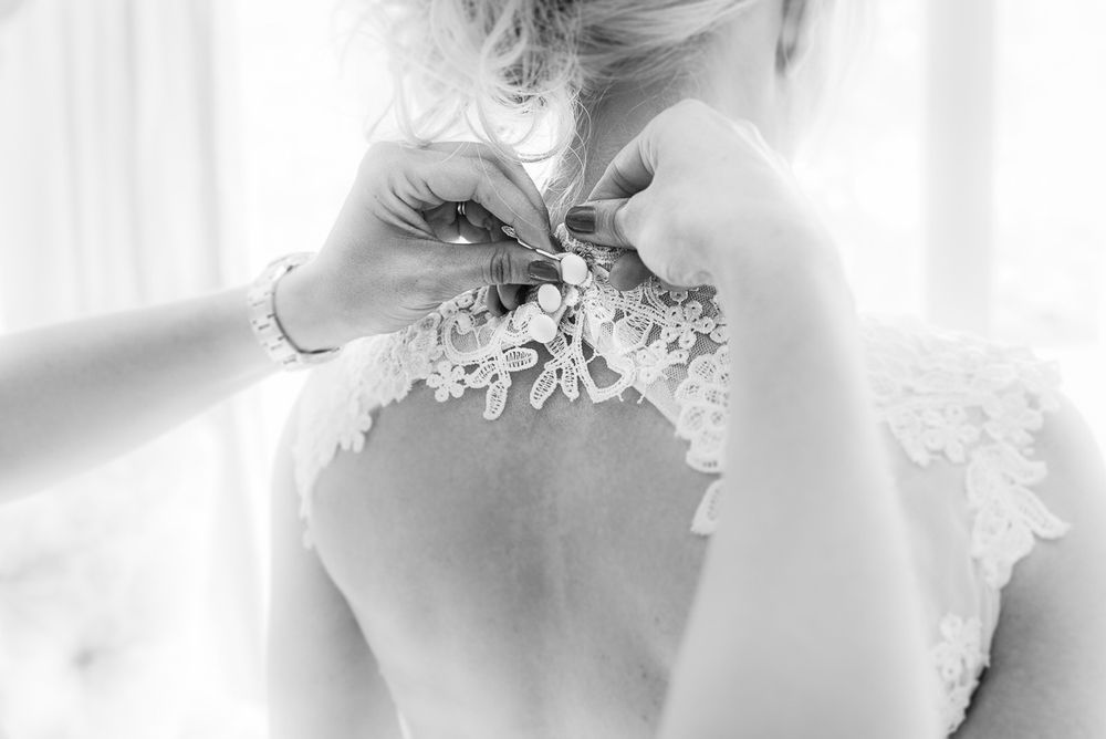 Bride getting her dress closed