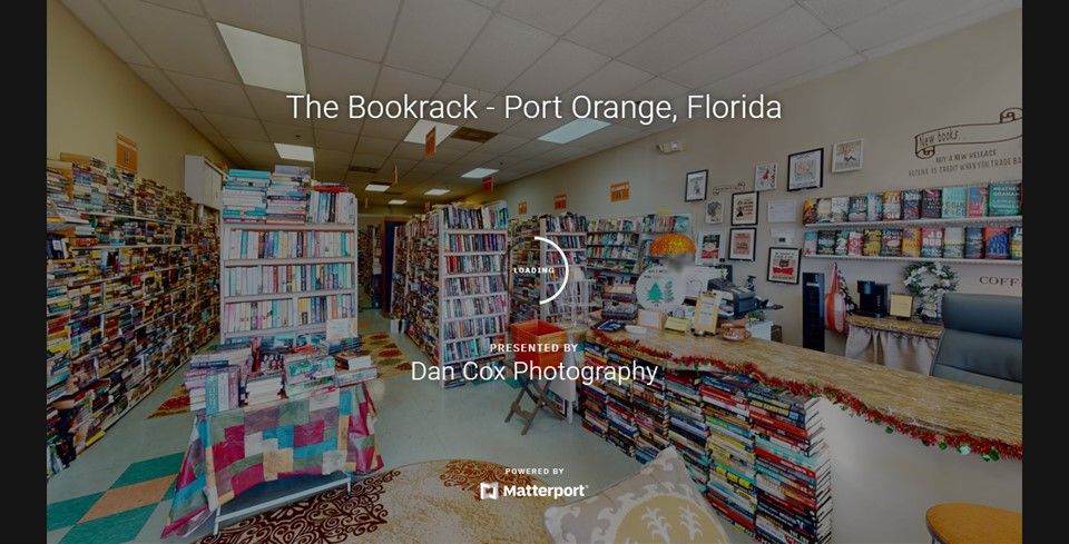 Interior view of a retail bookstore with rows of shelves and merchandise displays.