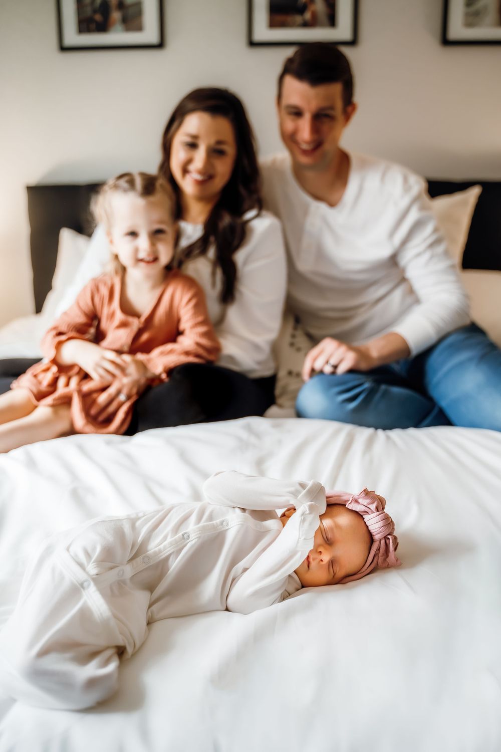 home newborn session with family wearing white outfits