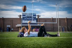 boy senior pictures with football
