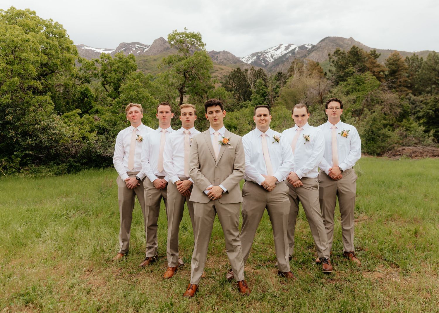 Groomsmen posing with groom in Utah mountain wedding