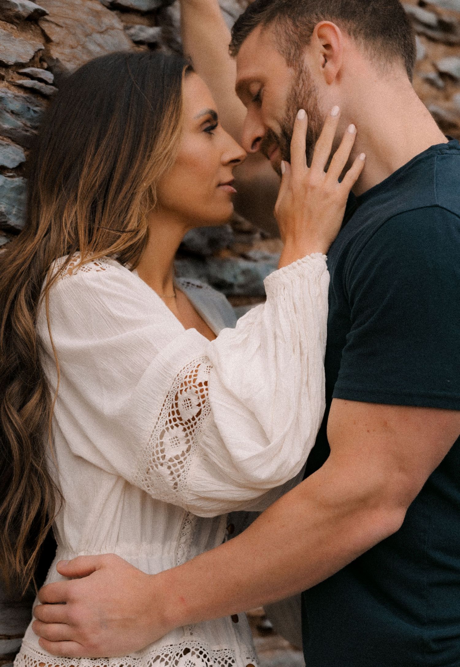 Couple photo session in Fredrick County, MD. Romantic couple embracing intimately against a natural backdrop in a photo series.