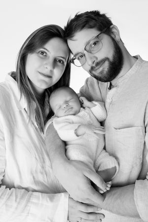 Intimate black and white family portrait with newborn baby.