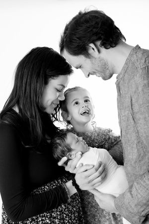 Black and white portrait of family sharing joyful moment together.
