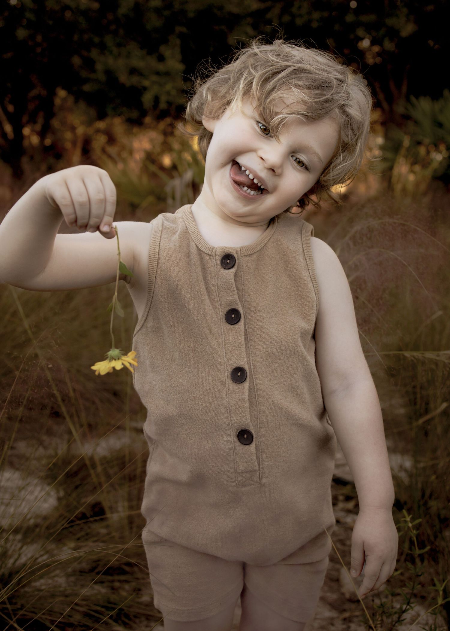 A joyful moment capturing pure childhood happiness in a warm sepia tone outdoor portrait.