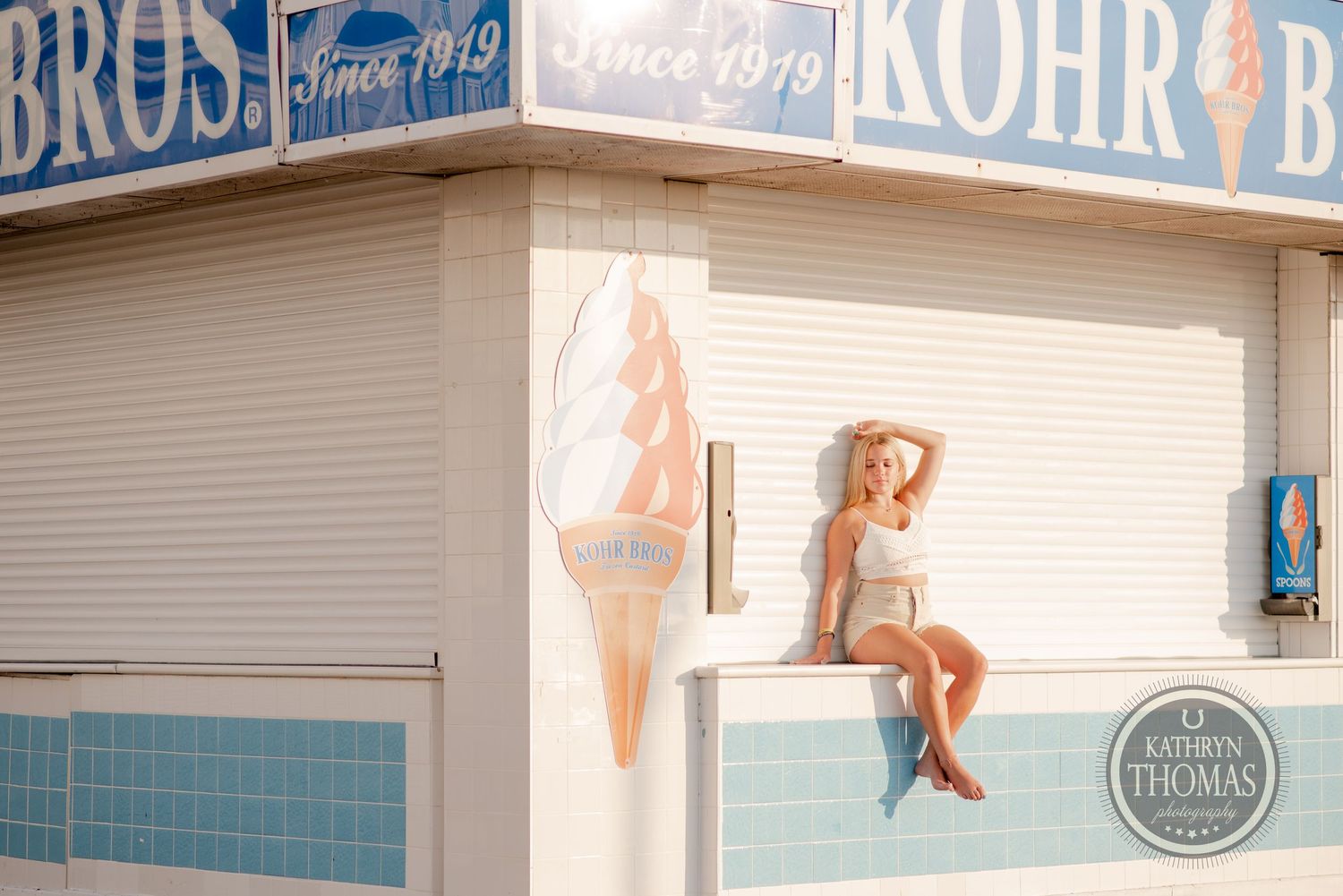 Vintage ice cream shop exterior with retro signage and decorative wall art on a sunny day.