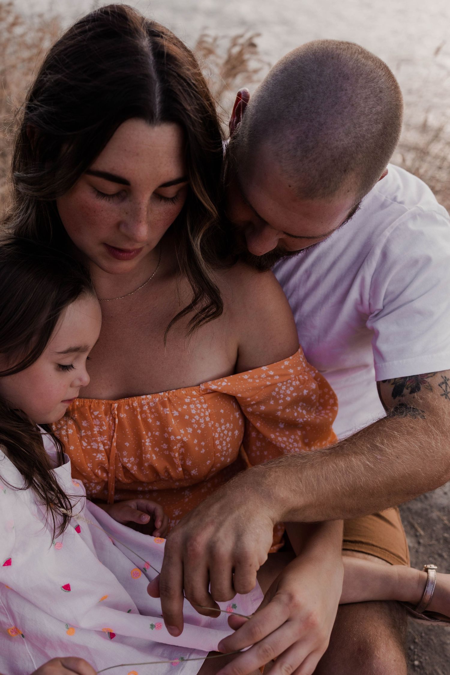 Intimate family moment captured in warm evening light.
