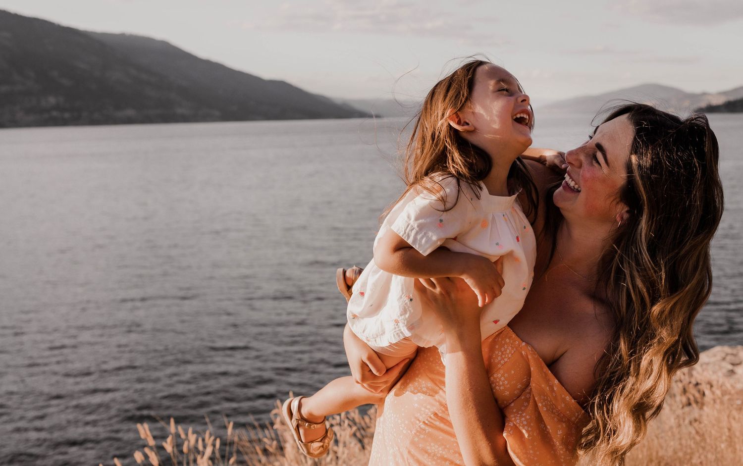Joyful outdoor moment with natural laughter and golden sunlight.