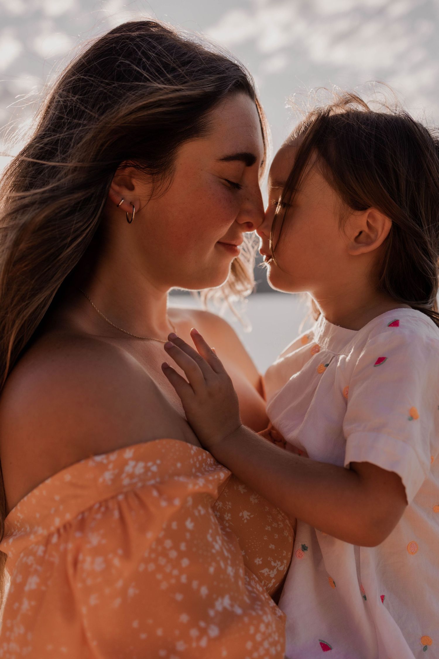 Close-up of intimate bonding moment in golden afternoon light.