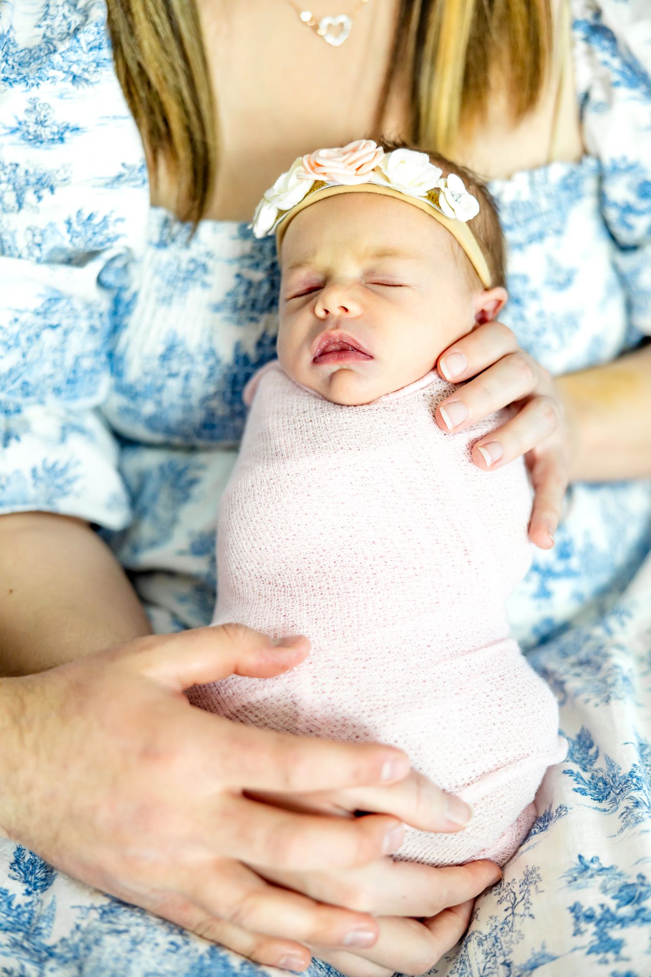 Close up of baby girl held in her mom's lap during lifestyle newborn photos in Colorado Springs.