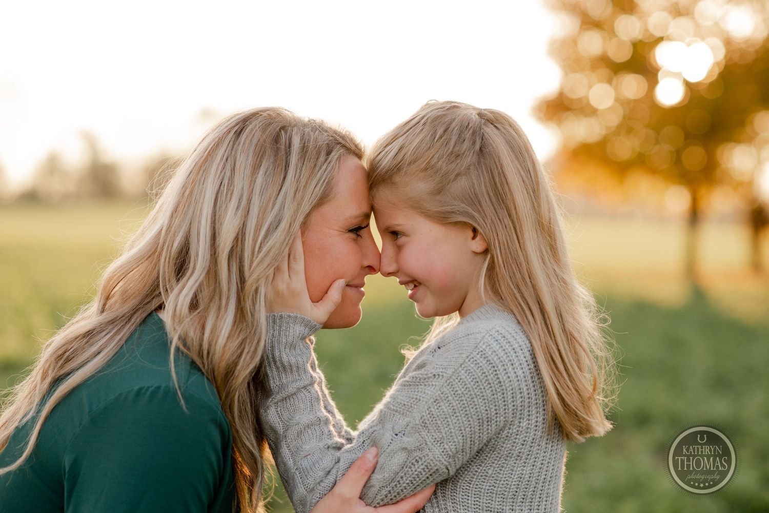 An intimate portrait of two people sharing a close moment at sunset.