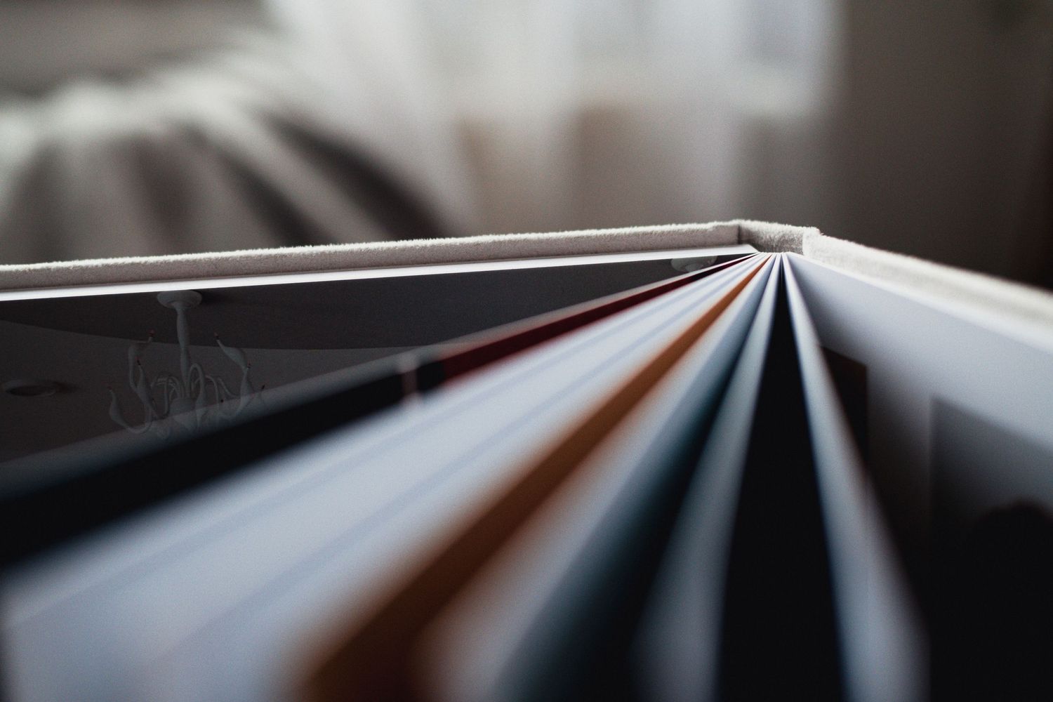 Abstract view of photo album pages fanning out in a geometric pattern.