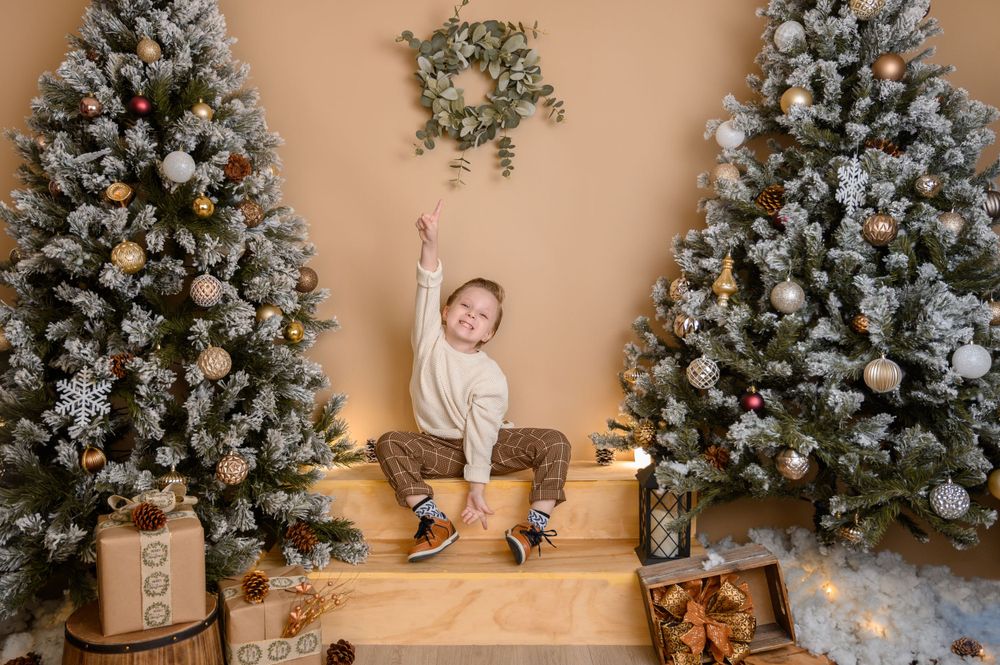 Cozy holiday scene with beautifully decorated Christmas trees and wooden crate props.