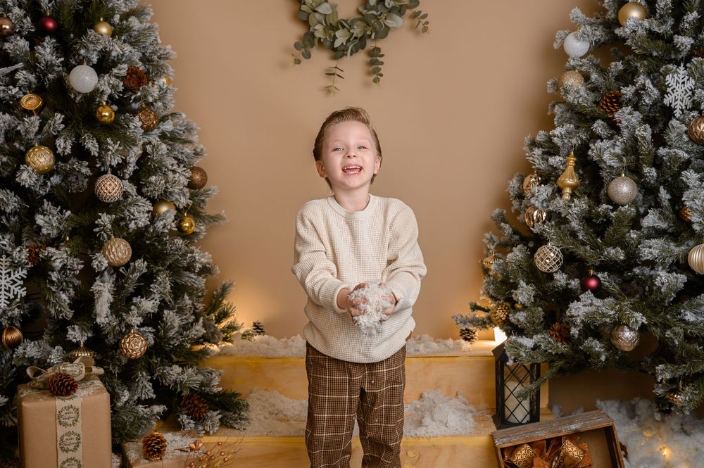 Warm Christmas setting with flocked trees, decorative ornaments, and rustic wooden elements.