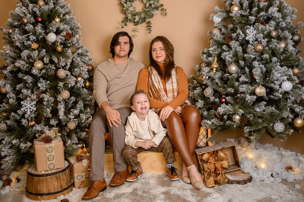 Holiday photo setting with multiple flocked Christmas trees and rustic wooden decorations.