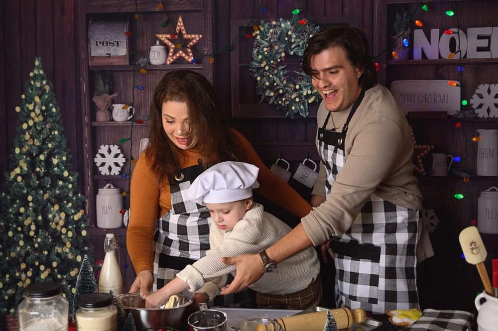 Holiday baking scene with rustic decor, plaid patterns, and Christmas lights in background.