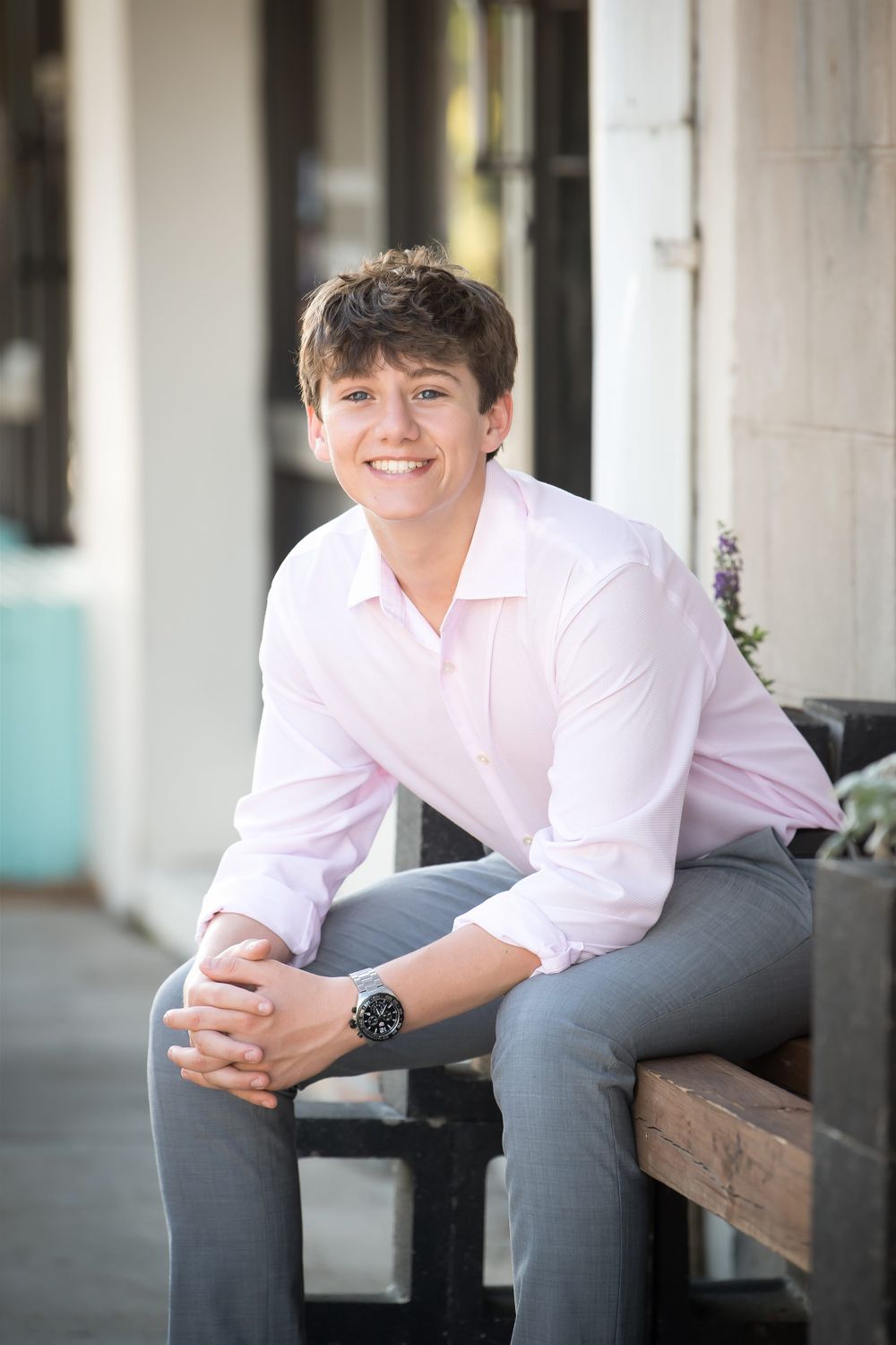 Modern portraits on concrete bench showing casual poses in business attire.