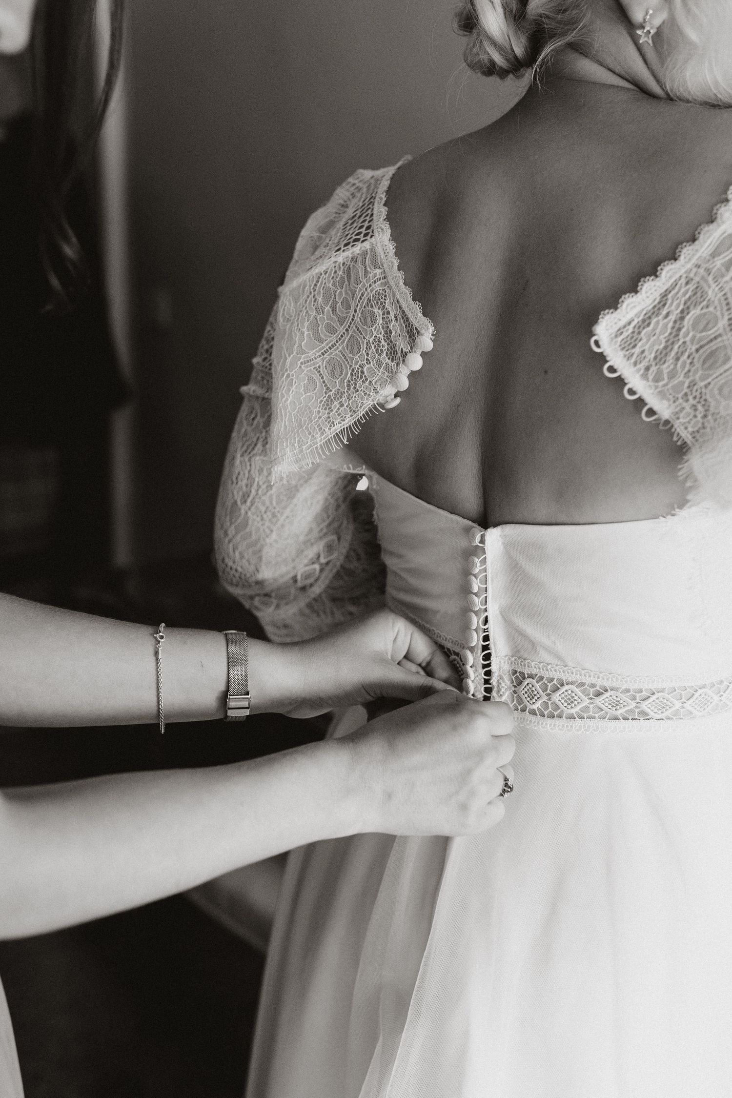 70s inspired lace wedding dress being done up