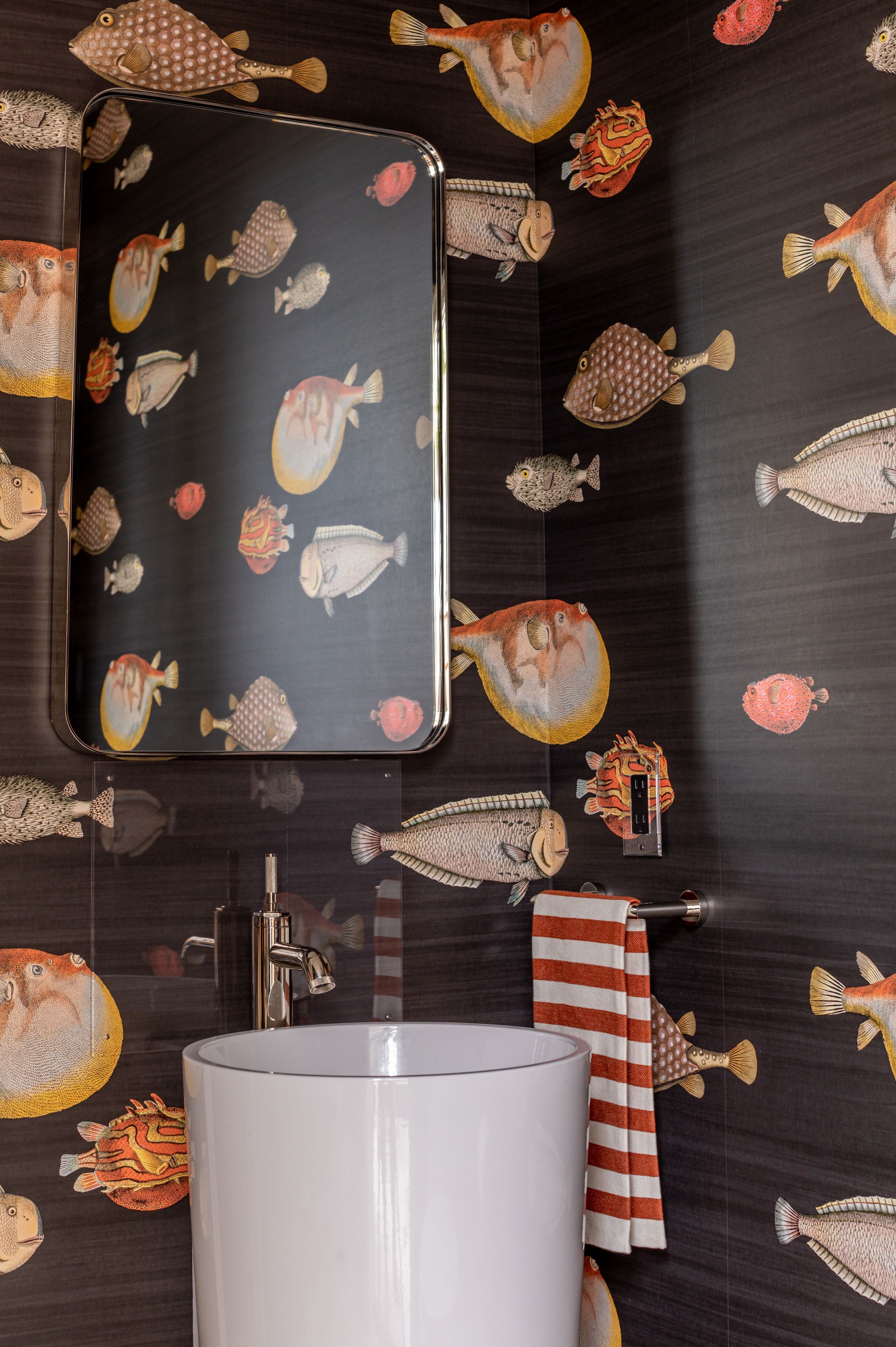 Black and orange blowfish wall paper in high end bathroom