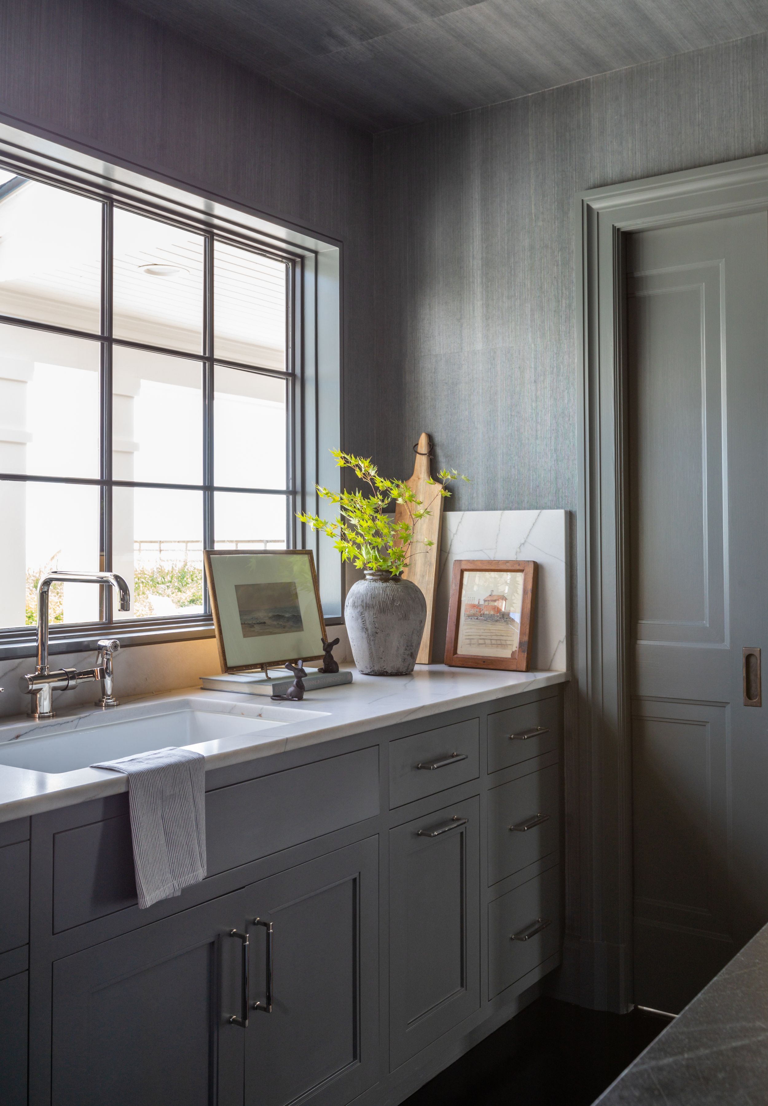 Updated traditional kitchen sink with paintings