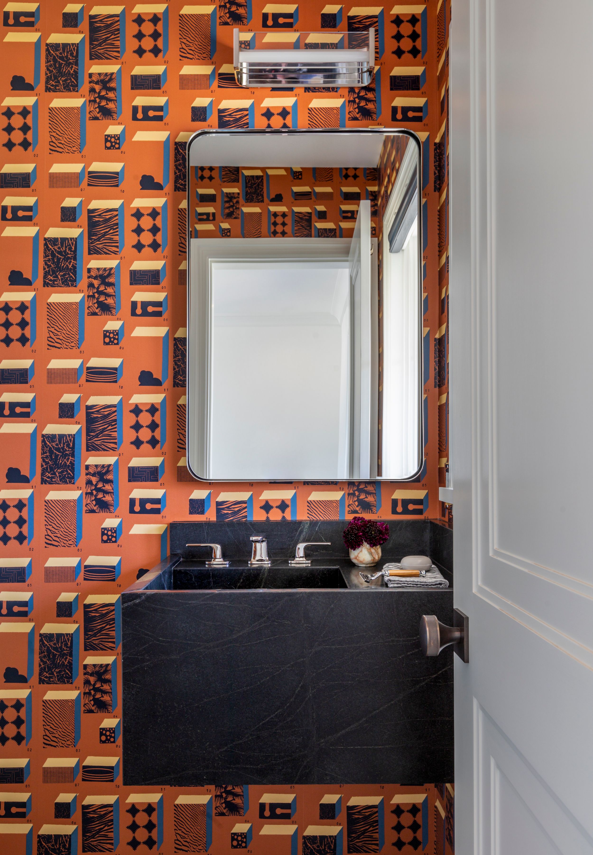 Luxury bathroom with orange Cannon & Bullock wall covering
