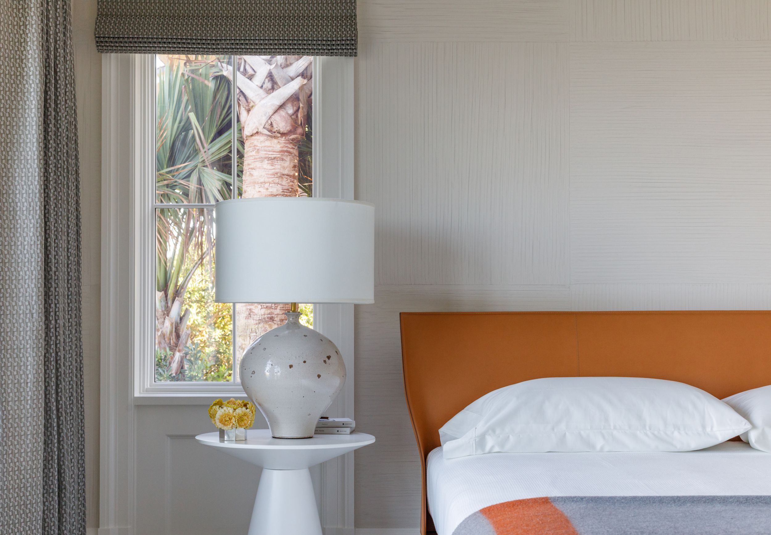 Luxury Men's coastal bedroom with Hermes orange bed frame