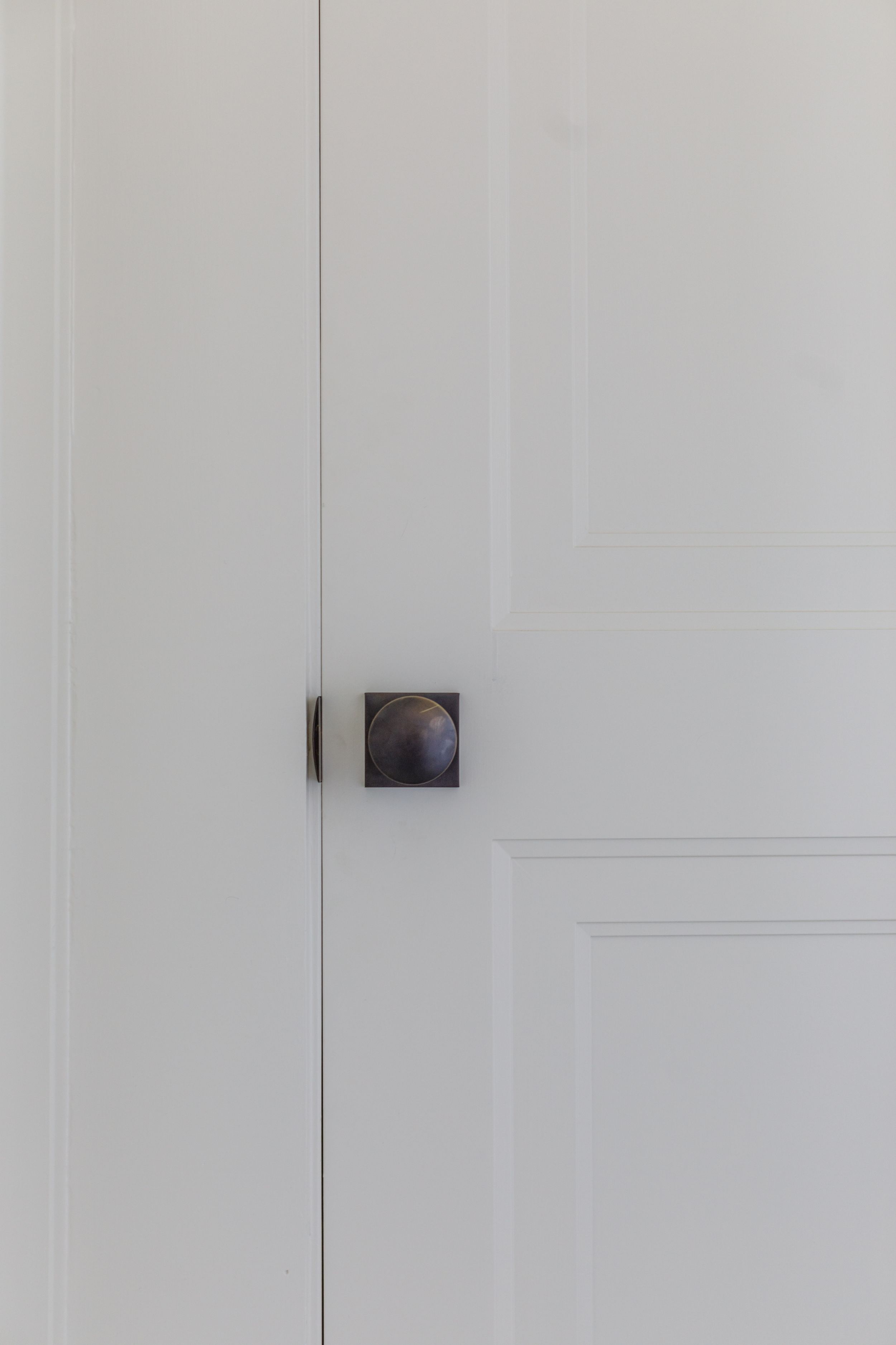 Custom moldings on door with classic iron doorknob