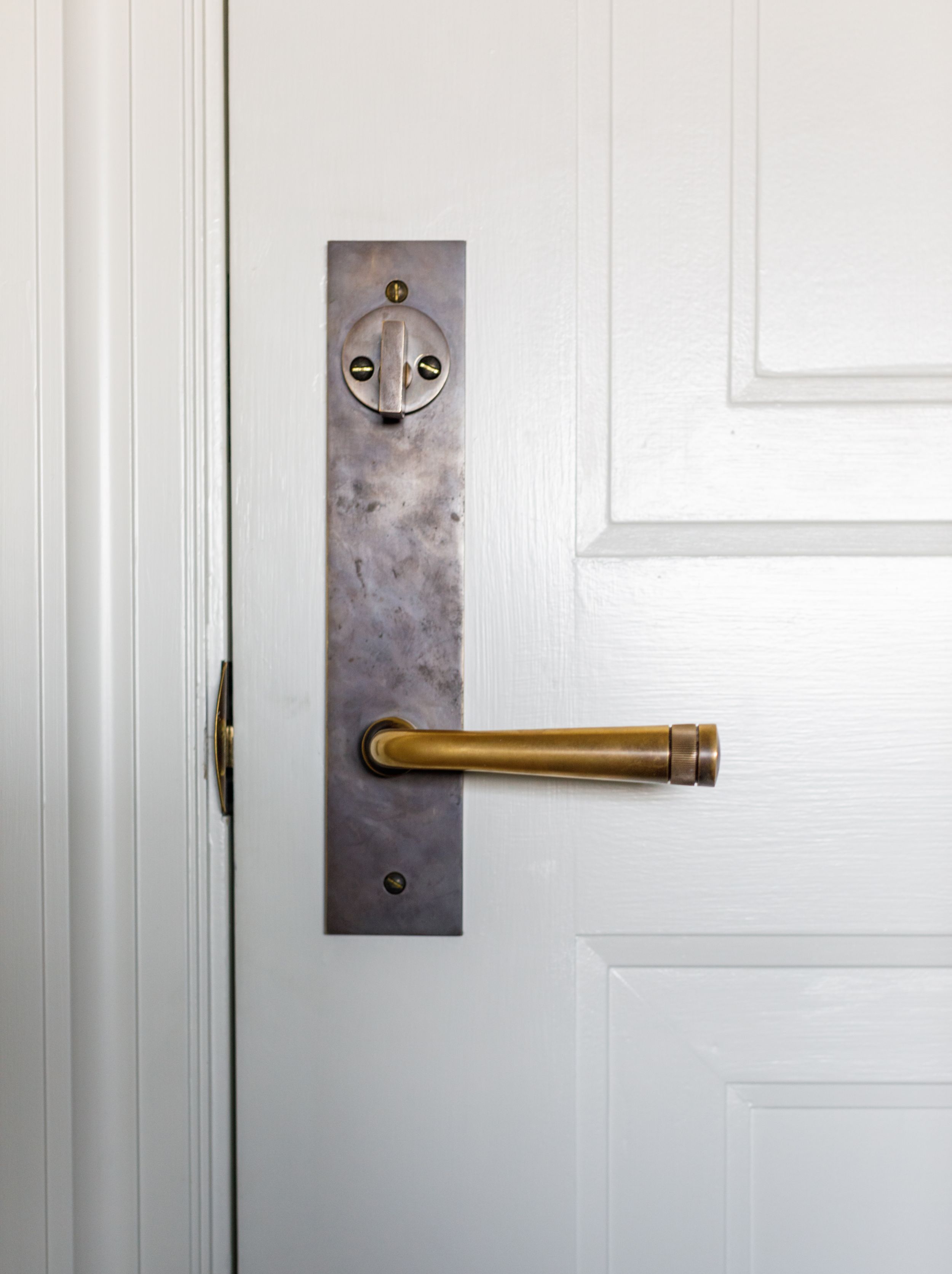 Custom moldings on door with brass doorknob