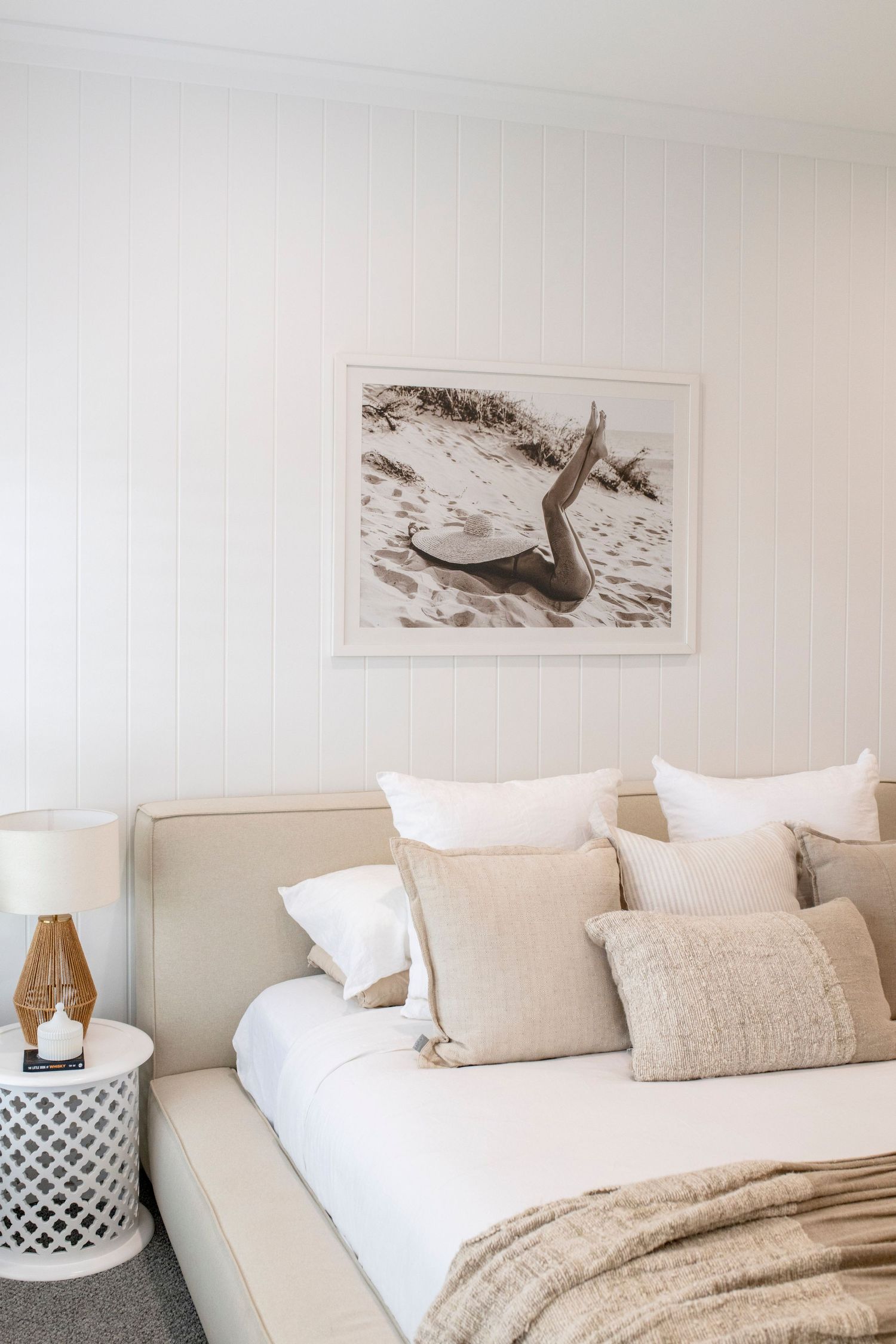 Gorgeous styled main bedroom with beautiful print above bed.