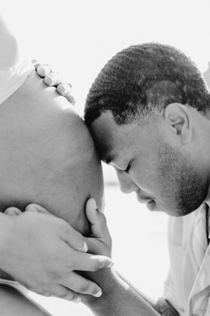 Intimate black and white maternity photos showing tender moments and embraces.