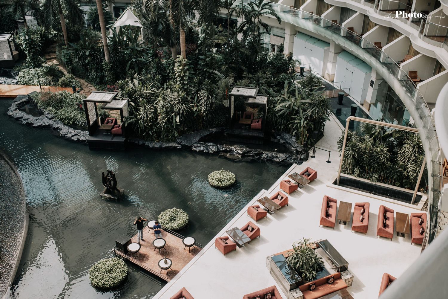 Overhead shot of a shopping center's central courtyard with seating areas and landscaping.
