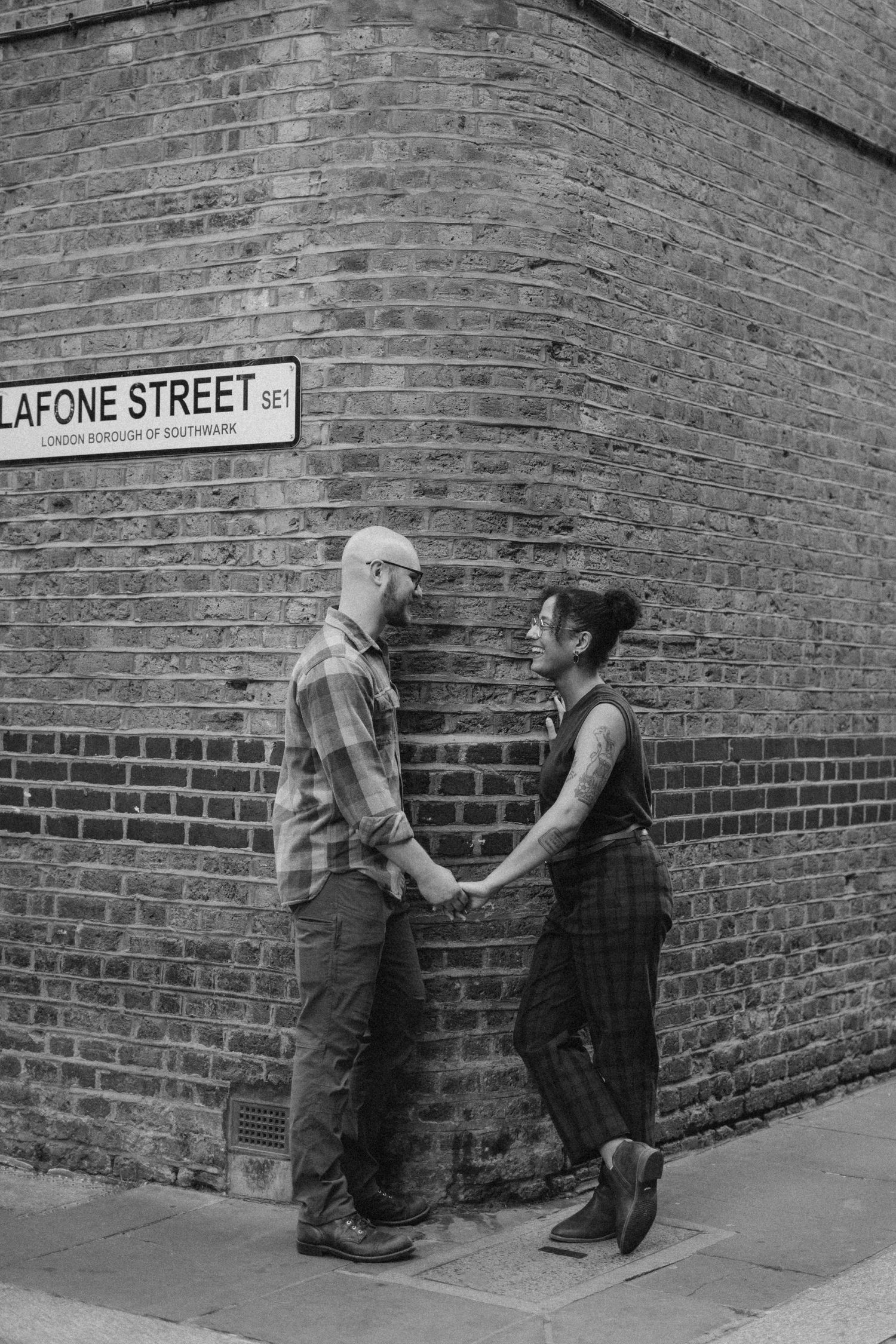 Couple is holding hands during their proposal photoshoot in London