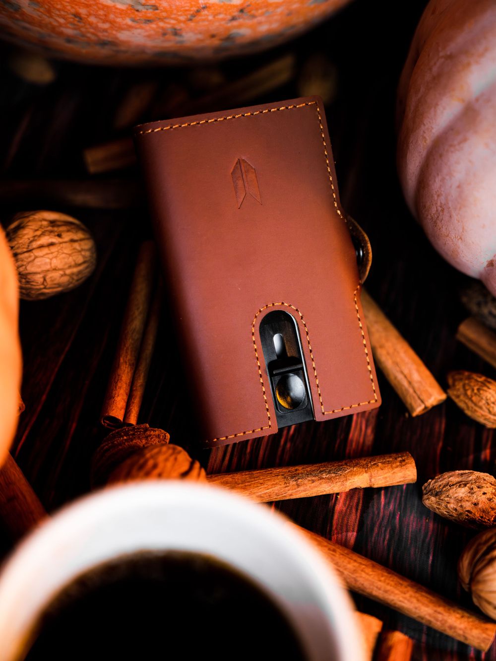 Leather wallet photographed in warm lighting with dramatic shadows and texture.