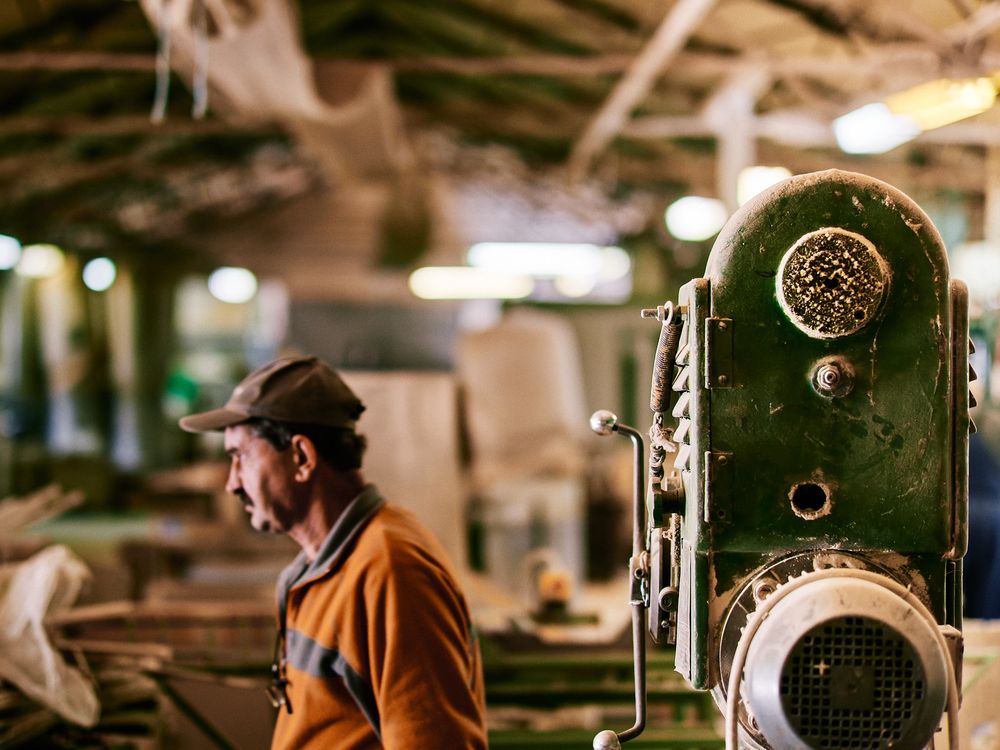 Vintage industrial machinery in a workshop with ambient lighting.