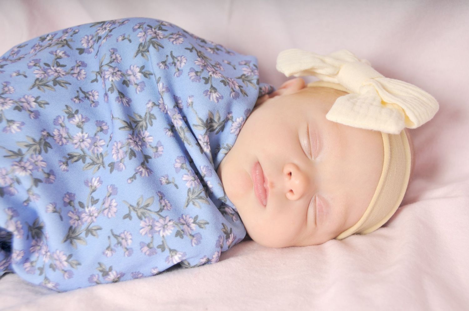 Newborn baby girl photo wrapped in floral fabric